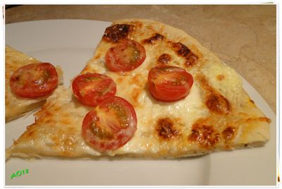 Pizza z mascarpone i pomidorkami koktajlowymi.